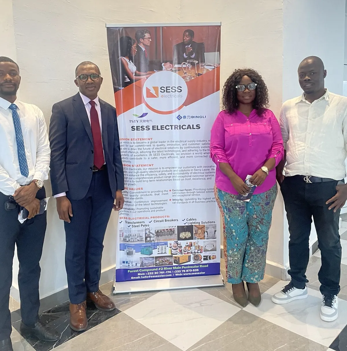 SLONEC staff with the SESS Electricals team beside the SESS banner