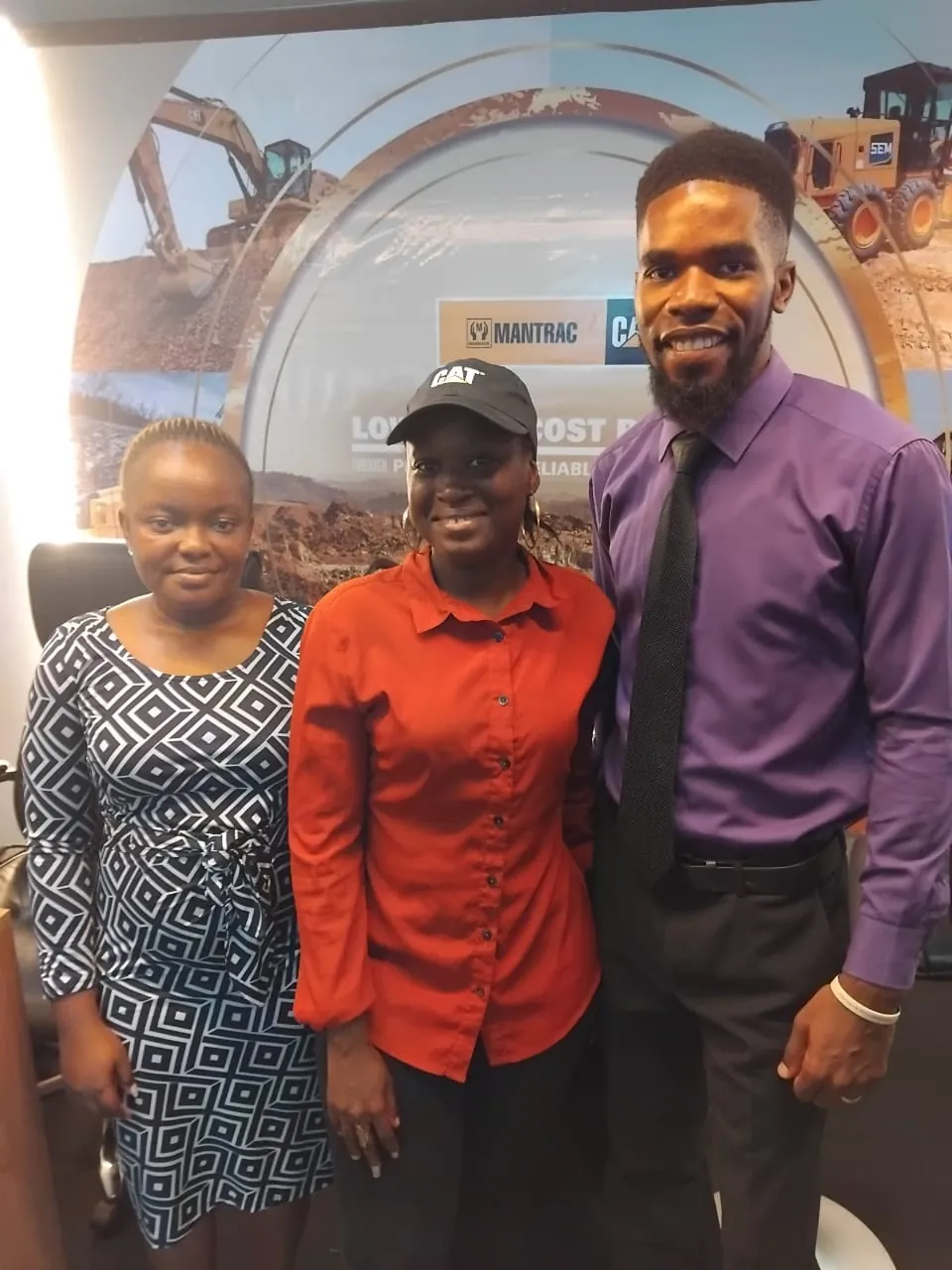 SLONEC team members with an exhibitor at Sierra Leone Mining Week 2025