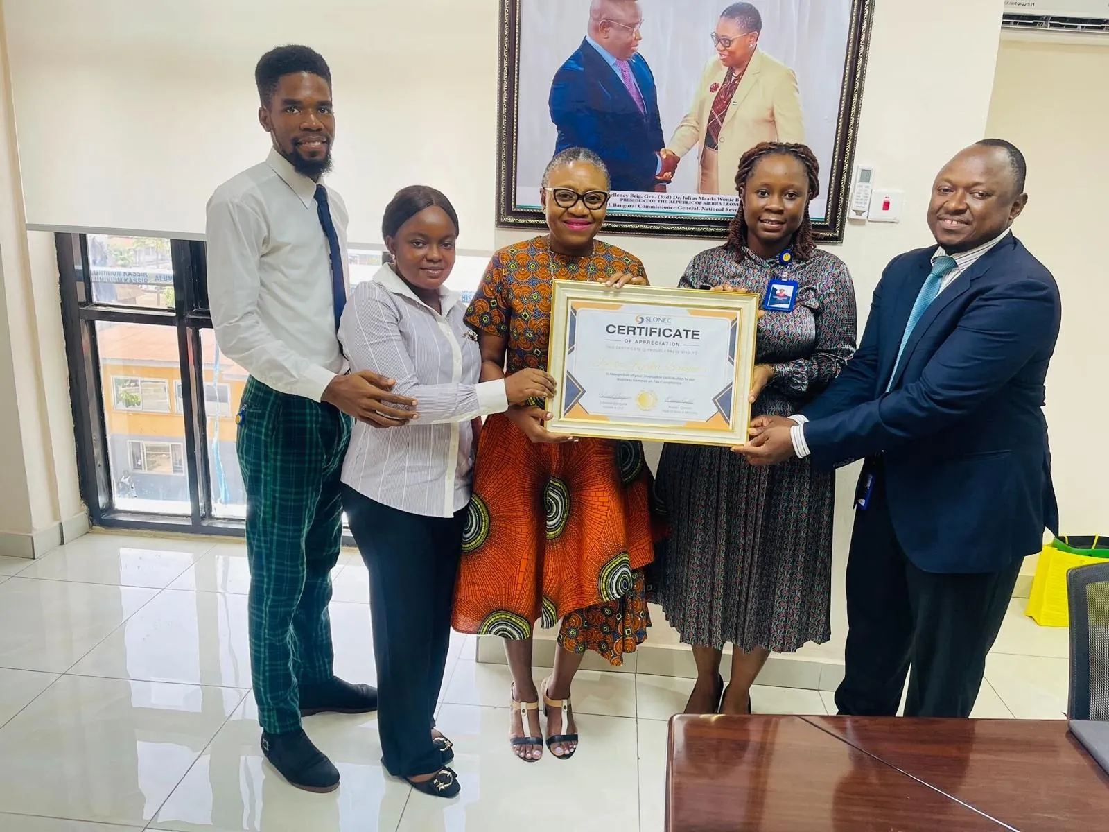 SLONEC presenting a certificate of honour to the NRA Commissioner General