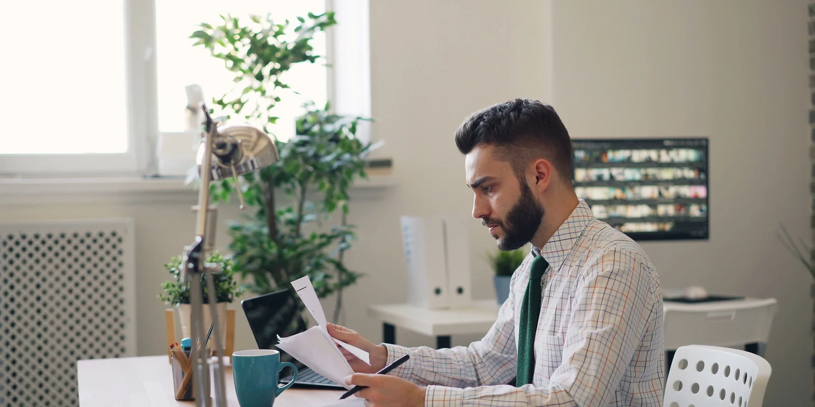 An adviser reviewing client documents at a desk