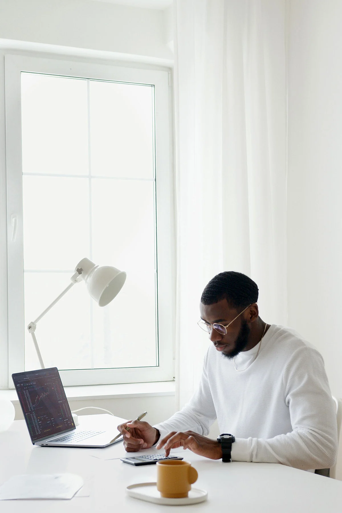An adviser working at a desk in a bright office