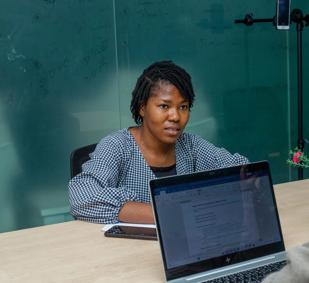 An accountant meeting a client to review their accounts on a laptop