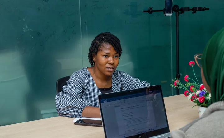 An accountant meeting a client to review their accounts on a laptop