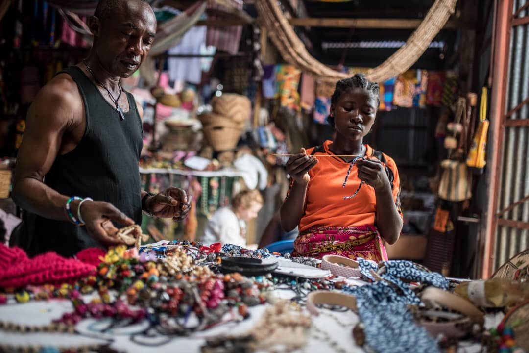 A trader and his assistant at their stall in the Big Market, Freetown