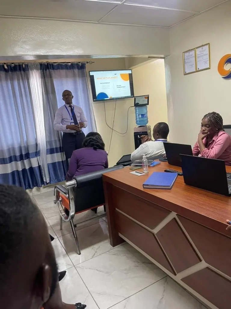 SLONEC adviser leading a team working session at the SLONEC office in Freetown