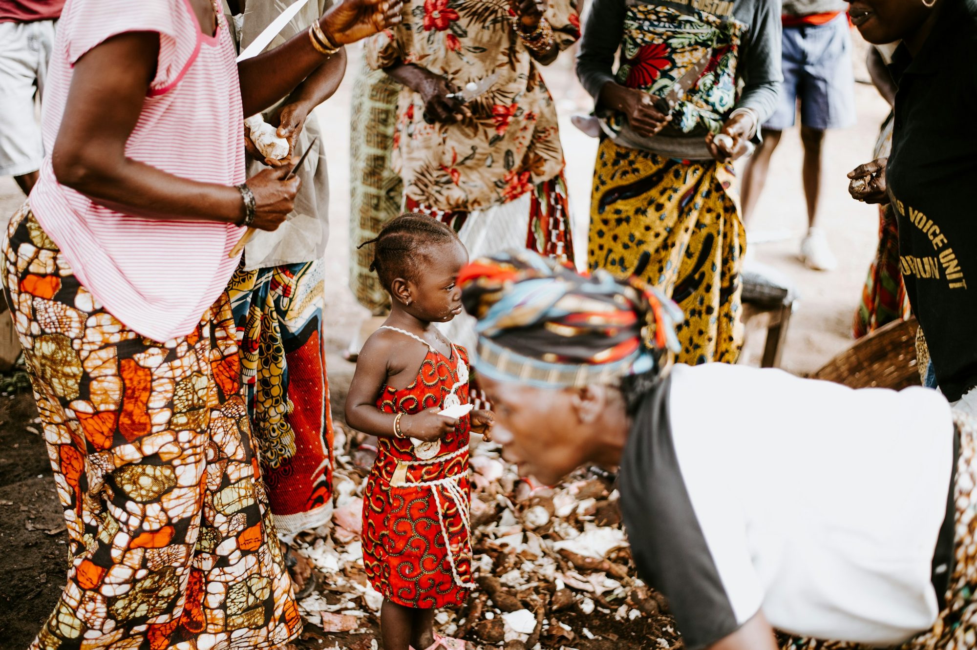 Women peeling harvested cassava together in Sierra Leone