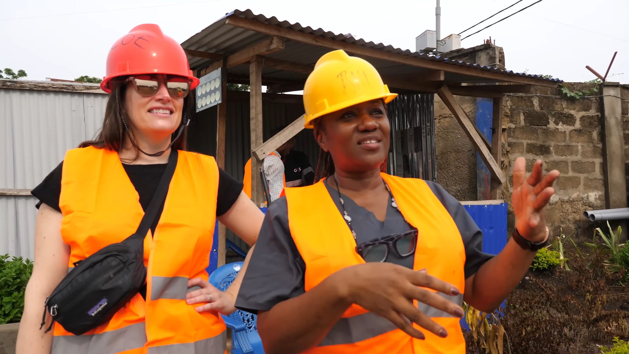 Construction team in hard hats and high-visibility vests on a building site in Sierra Leone