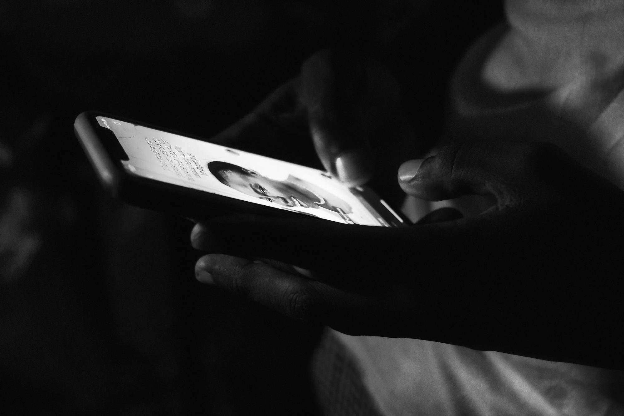 A person using a smartphone in Freetown, Sierra Leone